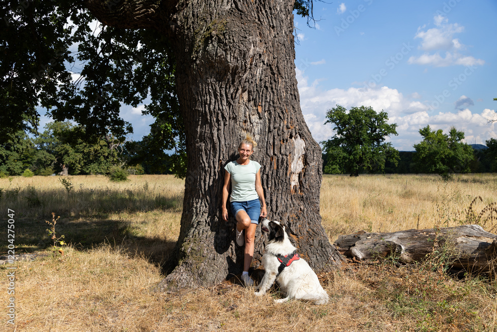 Fototapeta premium woman hugging a huge tree