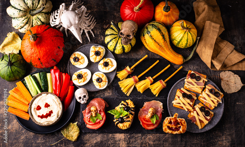 Halloween appetizers with pumpkin hummus deviled eggs and mummy snacks