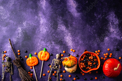 Halloween pumpkin jack-o-lantern candy with different sweets