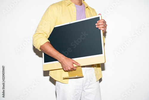 Young Man Carrying Yellow Computer