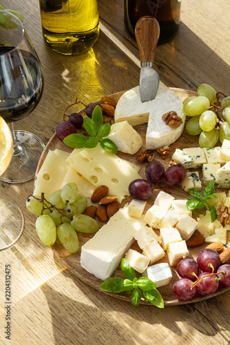 Gourmet cheese board with grapes almonds and wine for elegant appetizer or celebration