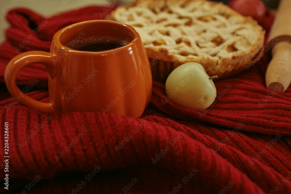 Obraz premium Homemade apple pie with a lattice top next to a cup of hot coffee and an open book, autumn leaf decor, cozy autumn reading setting, film grain effect, high-quality photo