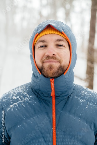 Canvastavla Man smiling enjoying solo winter hiking adventure