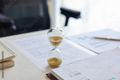 Картината върху платно Hourglass timer on minimalist office desk for time concept.