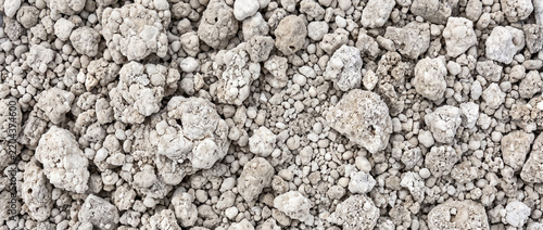 Fertilizer caking shown as a dense field of agglomerated granules with compact clusters and uneven crystalline texture