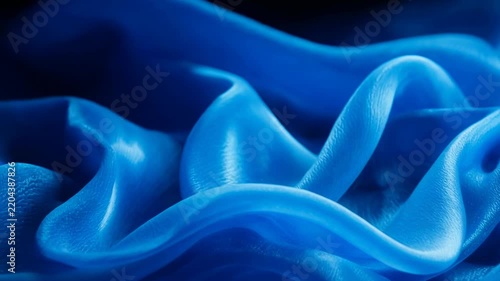 Abstract blue smoke waves flowing in darkness with subtle light shifts