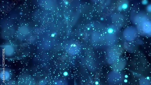 Abstract blue particles exploding in cinematic motion with bokeh background during night celebration