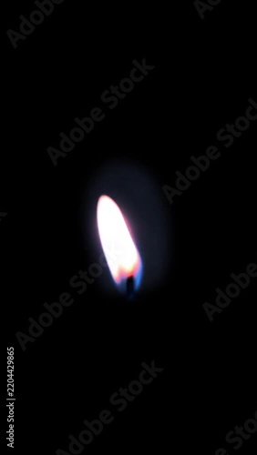 Vertical Single Candle Flame Burning on Isolated Black Background