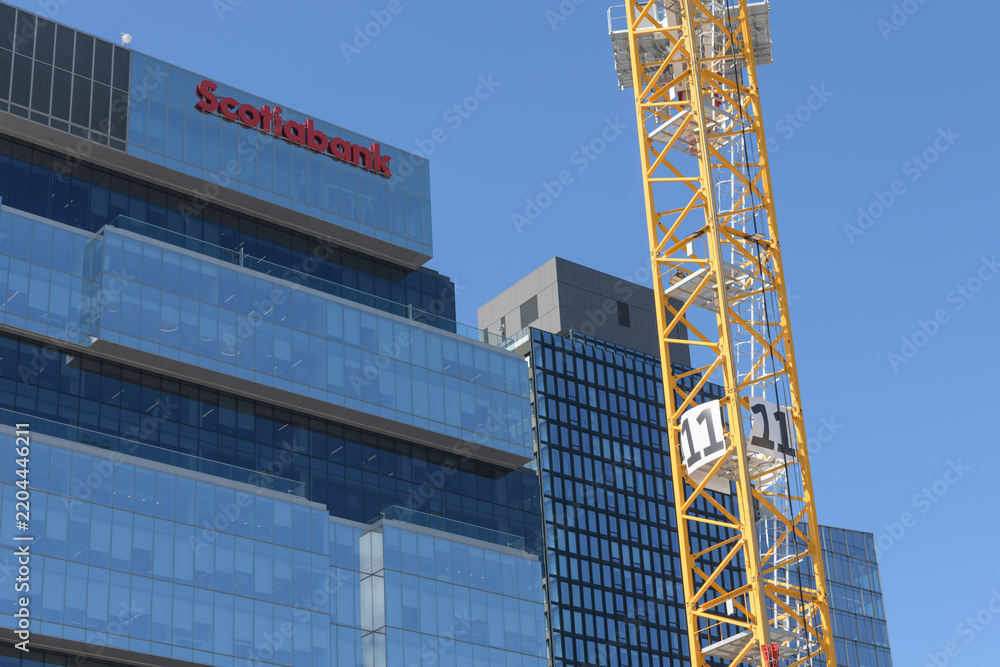 Obraz premium construction crane (Ontario Line site at Corktown) and east facing elevation of Globe and Mail Centre with Scotiabank sign at 351 King St E, Toronto
