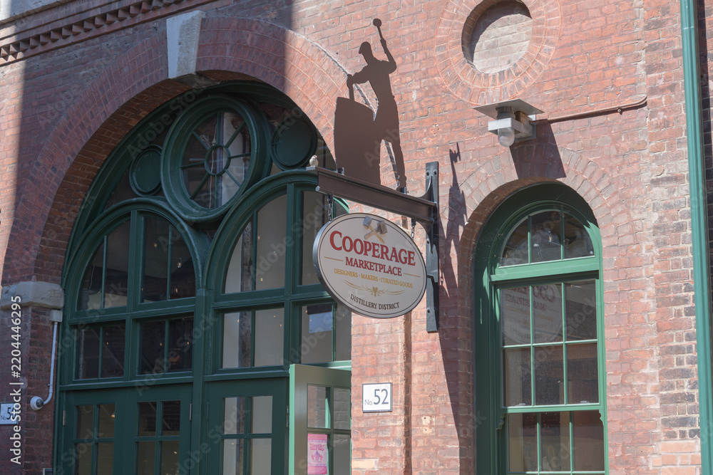 Obraz premium projecting sign outside entrance to The Cooperage Marketplace (historic barrel and cask maker) located at 52 Gristmill Lane, Distillery Historic District, Toronto