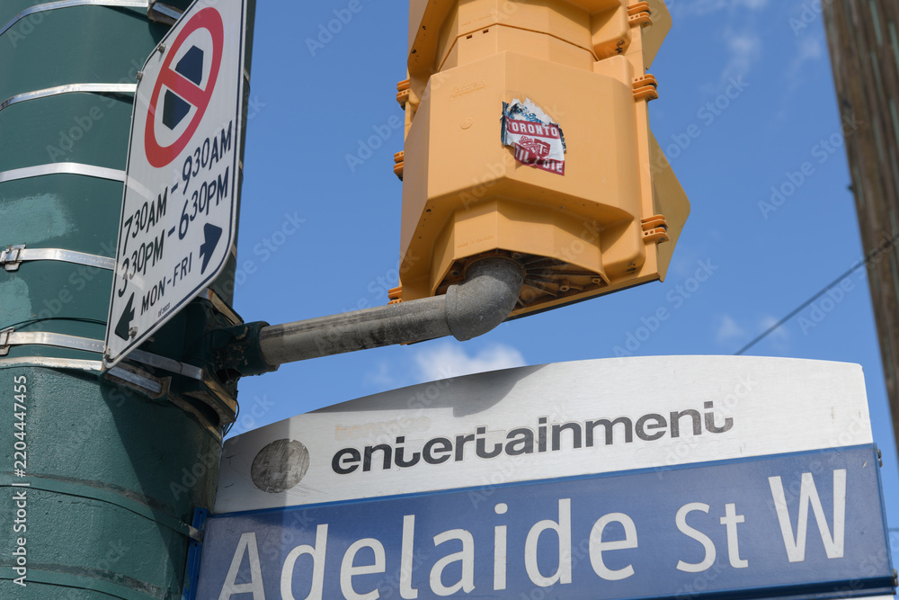 Fototapeta premium grungy Toronto FC stickers on the back of a crossing signal in the Entertainment District at Adelaide St W