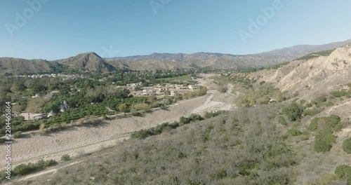 Aerial View of Dry River Channel Near Hillside Homes