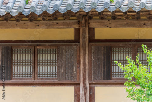 Traditional Korean hanok style temple living quarters facade featuring tiled eaves and wooden lattice windows in South Korea.