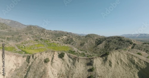 aerial view of badlands cliff face with eroded rock formations