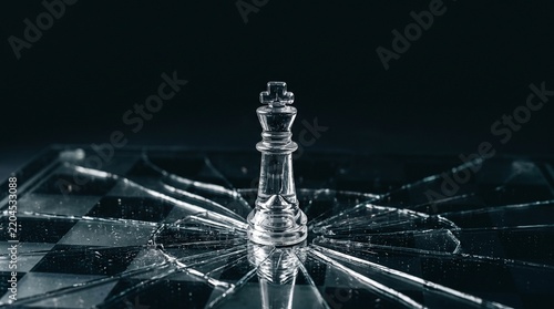 Glass chess piece on cracked mirror reflecting strategic conflict and crisis