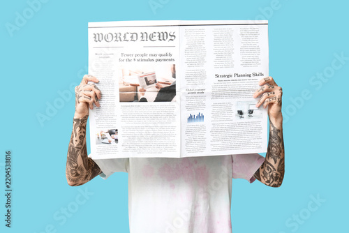 Man with newspaper on blue background