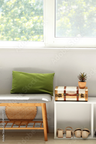 Interior of hall with soft bench and shelf unit
