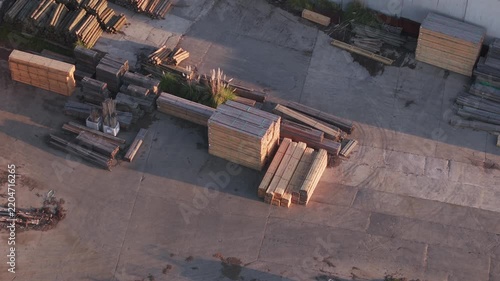 Aerial shot of shadows moving across a lumberyard at sunset