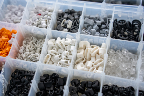 Konstfotografi Various plastic small parts sorted in compartmentalized containers