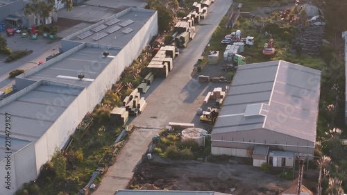 Aerial view of an industrial area with warehouses and solar panels