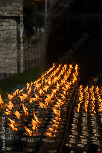 Thimphu Bhutan, view of flames of butter lamps at shrine