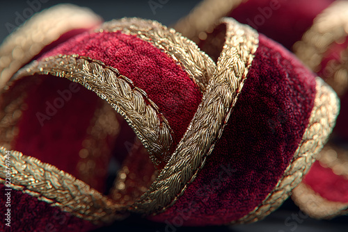 Luxurious Close-Up of Red Velvet Ribbon with Intricate Gold Trim for Holiday Decorations