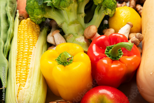 Different fresh vegetables as background.