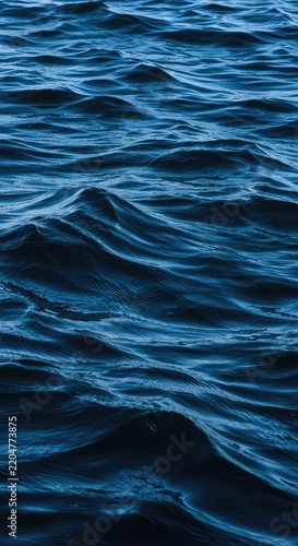 Dynamic surface of deep blue water forming massive, undulating waves reminiscent of large, fluid hills stretching to the horizon ,falling ,movement ,fluid