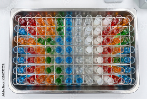Test Tubes Filled with Colorful Liquids in a Metal Rack
