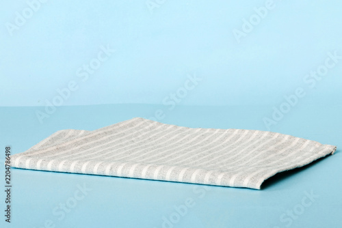 top view with gray kitchen napkin isolated on table background. Folded cloth for mockup with copy space, Flat lay. Minimal style