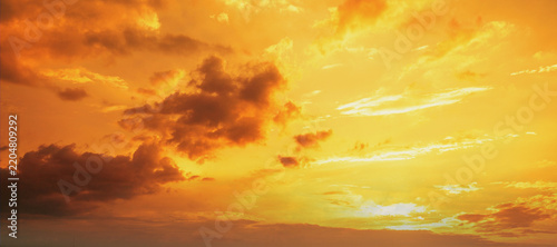 Orange cloudy sky at sunset. Gradient color. Sky texture. Abstract nature background