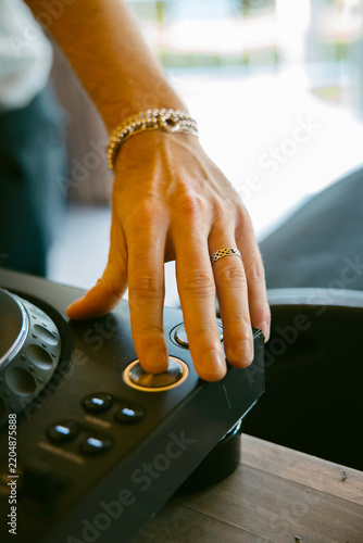 Close-up of DJ hand pressing CUE button on professional CDJ player