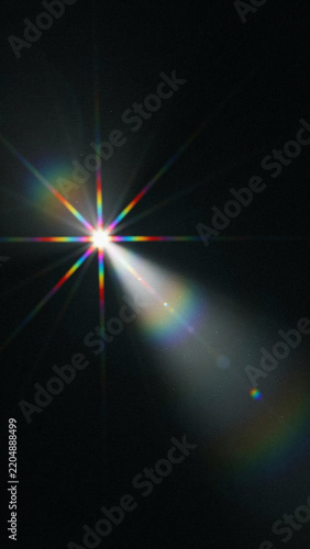 Bright starburst light effect with colorful lens flare black background isolated as PNG