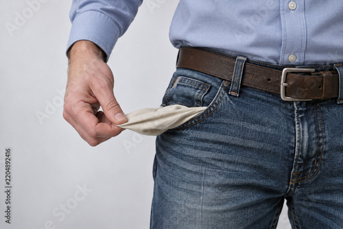 Man Pulling Out Empty Pants Pocket Showing He Is Broke