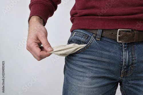 Man in Maroon Sweater Showing Empty Pants Pocket