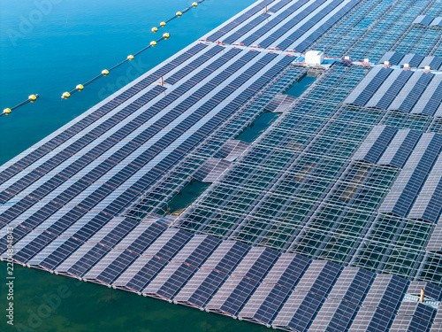 Aerial view of the floating solar farm at Cottbuser Ostsee, showing rows of solar panels on the water surface with some sections damaged by storm, located in Cottbus, Brandenburg, Germany.