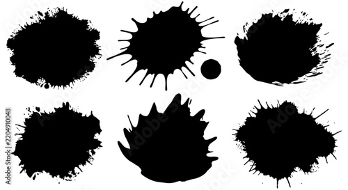 Black ink splatters with irregular edges on a white background