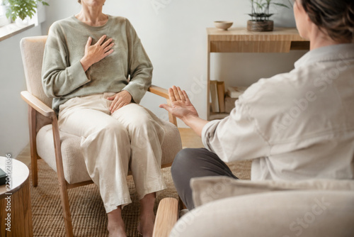 1 on 1 breathwork session with facilitator helps woman relax deeply and connect with her inner calm in cozy living room setting