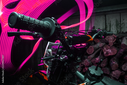 Artistic long-exposure night photos of a purple youth off-road enduro motorcycle