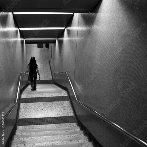 Girl descending stairs in Hong Kong underground