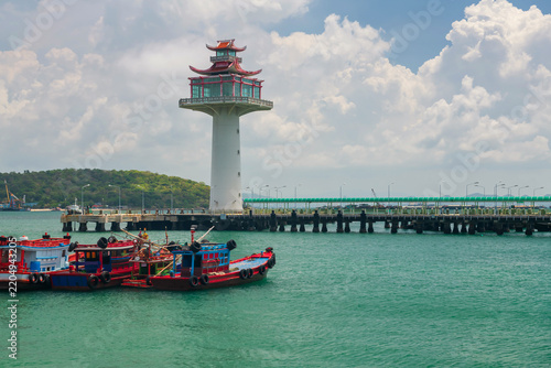 Fishing boats and Chinese style lighthouse observation. Koh Sichang