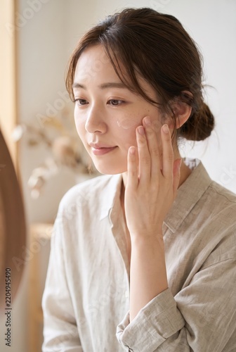 A hand rests on the cheek of a Japanese woman