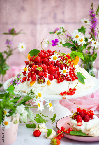 Delicious Pavlova meringue cake decorated with fresh summer berries