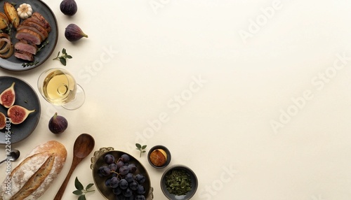 elegant seasonal dishes arranged primarily along the left and bottom edges of the frame, roasted meat, vegetables, figs, grapes