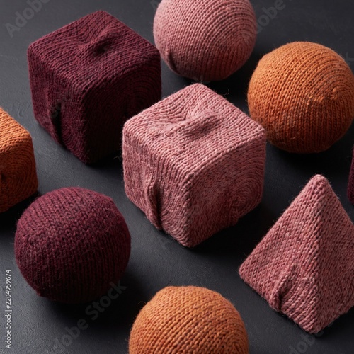 Collection of colorful knitted geometric objects.