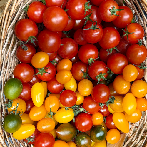 Mixed Cherry Tomatoes in a Woven Basket Seen From Above