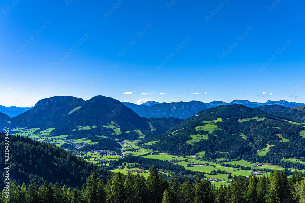 Fototapeta premium Beautiful panorama view of Soelllandl valley and Tyrolean Alps from mountain Brandstadl in summer on sunny day, Scheffau, Tyrol, Austria