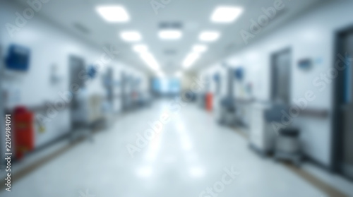 Blurred empty hospital corridor with medical equipment and brigh