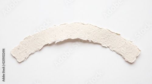 A textured, torn paper arc with a rough, fibrous edge rests on a plain background, suggesting a creative or crafting element.