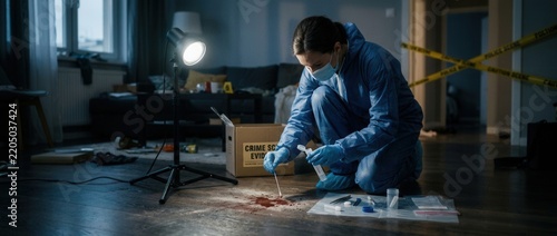 Forensic Investigator in Protective Suit Collecting Evidence at Crime Scene Examining Blood Stain on Floor